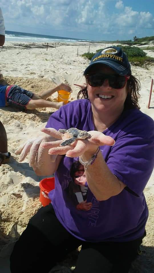 Dori holding a baby turtle